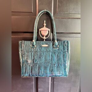 Deep teal glossy Kate Spade purse. Pale gold hardware. A few marks on it.